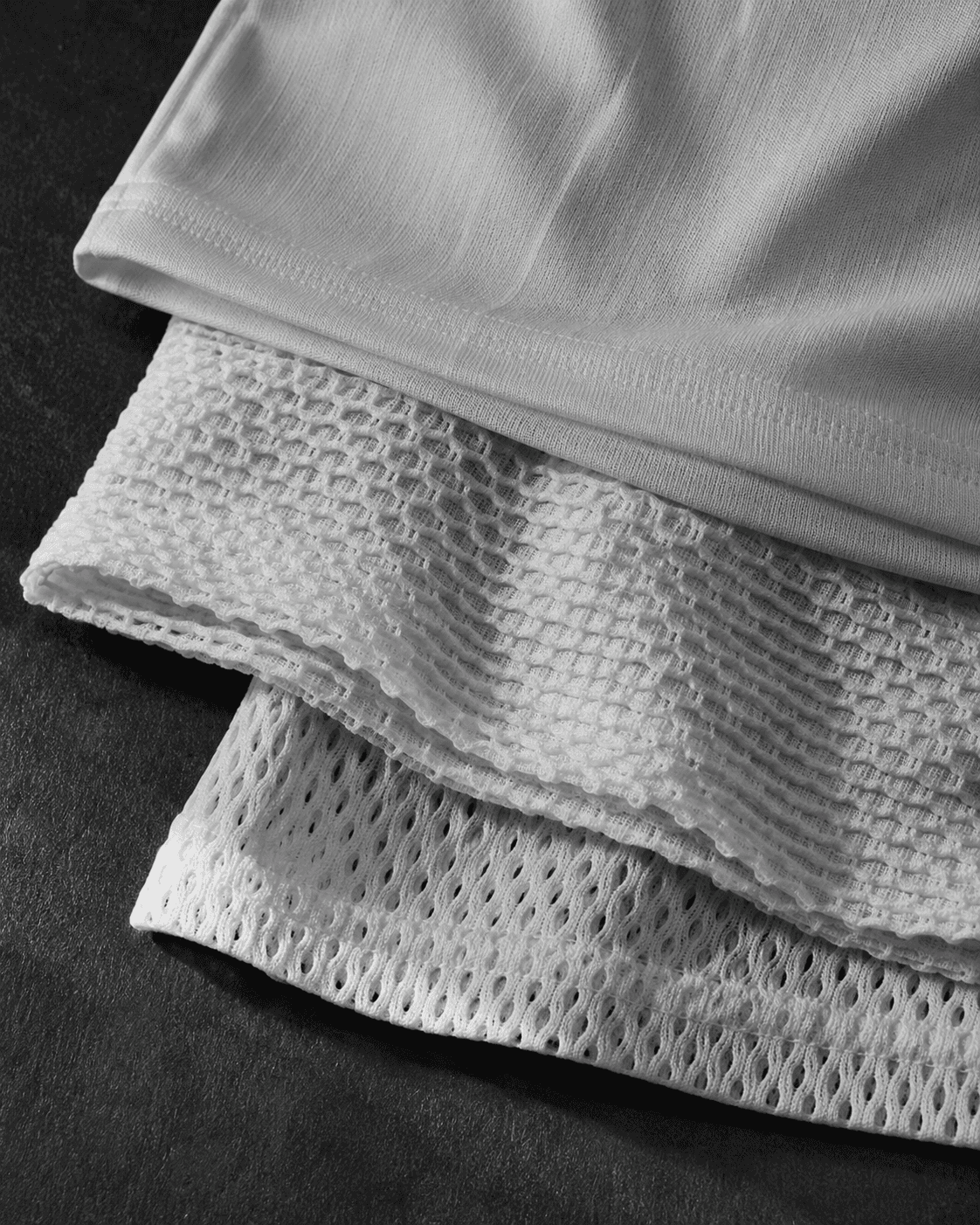 Three Malin performance tees showing different weave structures side by side