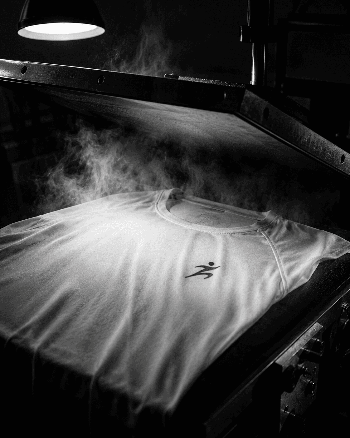 A Malin garment on a heat press under rising steam